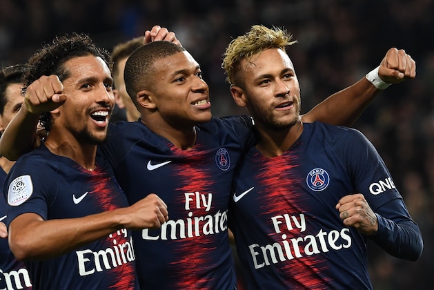 Paris Saint-Germain's French forward Kylian Mbappe (C) celebrates with Paris Saint-Germain's Brazilian forward Neymar (R) and Paris Saint-Germain's Brazilian defender Marquinhos after he scored a goal during the French L1 football match between Paris Saint-Germain (PSG) and Olympique de Lyon (OL) on October 7, 2018 at the Parc des Princes stadium in Paris. (Photo by Anne-Christine POUJOULAT / AFP)        (Photo credit should read ANNE-CHRISTINE POUJOULAT/AFP/Getty Images)