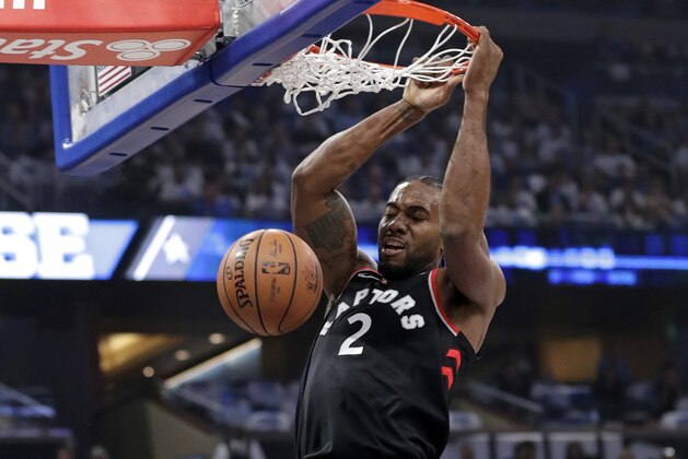 Toronto Raptors' Kawhi Leonard makes an uncontested dunk against the Orlando Magic during the first half in Game 3 of a first-round NBA basketball playoff series, Friday, April 19, 2019, in Orlando, Fla. (AP Photo/John Raoux)