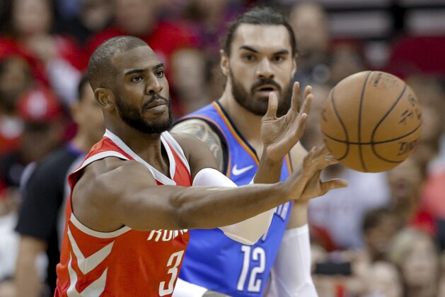 Houston Rockets guard Chris Paul (3) passes the ball in front of Oklahoma City Thunder center Steven Adams (12) during the first half of an NBA basketball game Saturday, April 7, 2018, in Houston. (AP Photo/Michael Wyke)