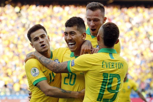 Brazil's Roberto Firmino, center, celebrates scoring his side's second goal against Peru with teammates Phlippe Coutinho, left, and Everton, right, during a Copa America Group A soccer match at the Arena Corinthians in Sao Paulo, Brazil, Saturday, June 22, 2019. (AP Photo/Victor R. Caivano)