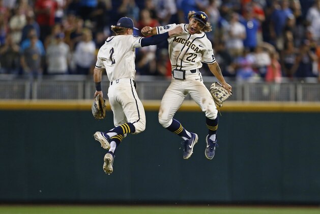 Michigan right fielder Jordan Brewer (22) celebrates with Michigan shortstop Jack Blomgren (2) after Michigan defeated Vanderbilt in Game 1 of the NCAA College World Series baseball finals in Omaha, Neb., Monday, June 24, 2019. (AP Photo/John Peterson)