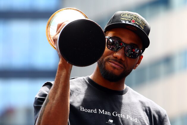 TORONTO, ON - JUNE 17:  Kawhi Leonard #2 of the Toronto Raptors holds the MVP trophy during the Toronto Raptors Victory Parade on June 17, 2019 in Toronto, Canada. The Toronto Raptors beat the Golden State Warriors 4-2 to win the 2019 NBA Finals.  NOTE TO USER: User expressly acknowledges and agrees that, by downloading and or using this photograph, User is consenting to the terms and conditions of the Getty Images License Agreement.  (Photo by Vaughn Ridley/Getty Images)