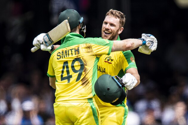 LONDON, ENGLAND - JUNE 25: Aaron Finch of Australia (R) celebrates reaching his century with team mate Steve Smith during the Group Stage match of the ICC Cricket World Cup 2019 between England and Australia at Lords on June 25, 2019 in London, England. (Photo by Andy Kearns/Getty Images)