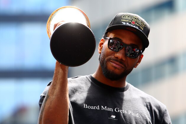 TORONTO, ON - JUNE 17:  Kawhi Leonard #2 of the Toronto Raptors holds the MVP trophy during the Toronto Raptors Victory Parade on June 17, 2019 in Toronto, Canada. The Toronto Raptors beat the Golden State Warriors 4-2 to win the 2019 NBA Finals.  NOTE TO USER: User expressly acknowledges and agrees that, by downloading and or using this photograph, User is consenting to the terms and conditions of the Getty Images License Agreement.  (Photo by Vaughn Ridley/Getty Images)
