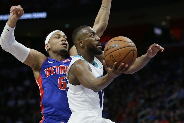 Charlotte Hornets guard Kemba Walker (15) goes to the basket past Detroit Pistons guard Bruce Brown (6) during the second half of an NBA basketball game Sunday, April 7, 2019, in Detroit. Walker scored 31 points in a 104-91 win over the Pistons. (AP Photo/Duane Burleson)