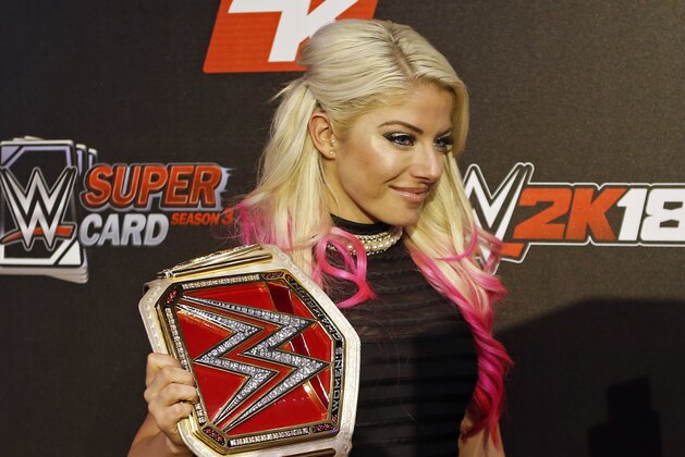 FILE - In this Aug. 18, 2017, file photo, WWE Superstar Alexa Bliss is seen at the WWE 2K18 SummerSlam Kickoff Event in New York. Bliss ditched her skimpy two-piece ring gear that helped make the former WWE champ one of the more alluring wrestlers in the company for a full bodysuit. Performing for the first time in the United Arab Emirates, where strict rules apply to how much of the body a woman can bare in public, Bliss wasn't about to risk offending a nation that was set to have WWE female wrestlers fight on the same card as the men. (Adam Hunger/Invision for 2K Games/AP Images)