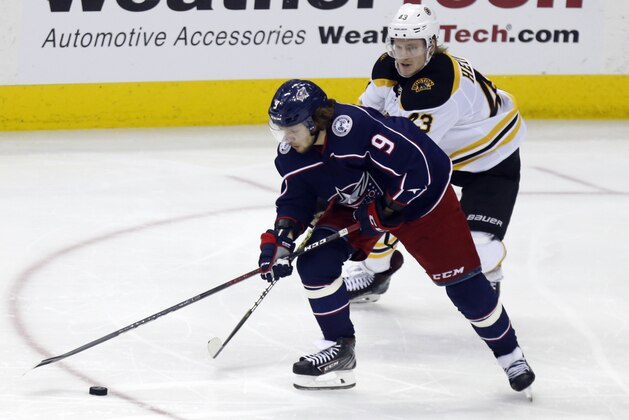 Columbus Blue Jackets forward Artemi Panarin, left, of Russia, works against Boston Bruins forward forward Danton Heinen during Game 4 of an NHL hockey second-round playoff series in Columbus, Ohio, Thursday, May 2, 2019. The Bruins won 4-1. (AP Photo/Paul Vernon)