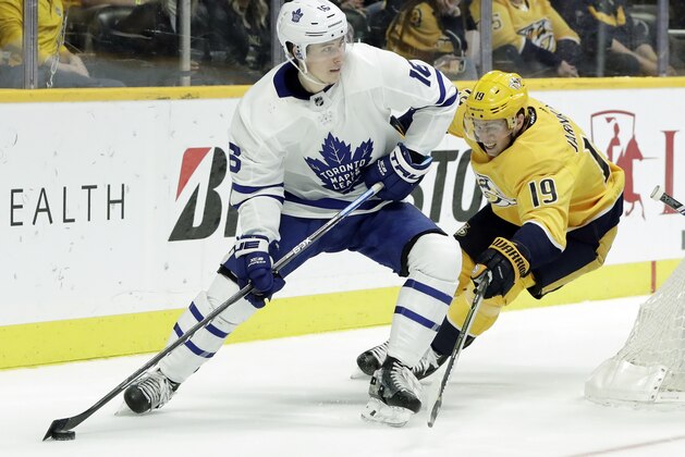 Toronto Maple Leafs right wing Mitchell Marner (16) is defended by Nashville Predators' Calle Jarnkrok (19), of Sweden, in the third period of an NHL hockey game Tuesday, March 19, 2019, in Nashville, Tenn. The Predators won 3-0. (AP Photo/Mark Humphrey)