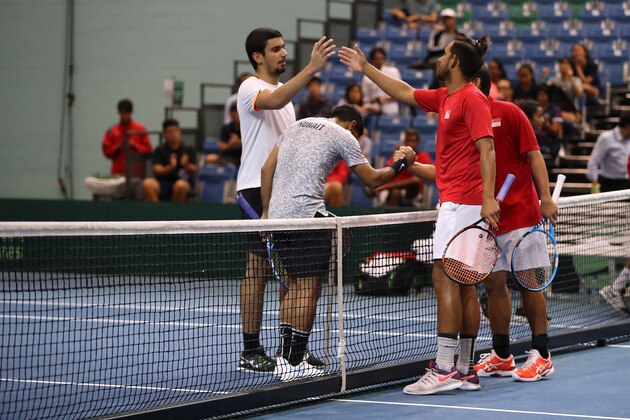 SINGAPORE, SINGAPORE - JUNE 26: Roy Hobbs and Jensen Hiu of Singapore celebrate match point during their Pool A mens doubles match against Abdulrahman Alawadhi and Essa Qabazard of Kuwait during day one of the Davis Cup Asia/Oceania Group III at OCBC Arena on June 26, 2019 in Singapore. (Photo by Lionel Ng/Getty Images for Singapore Sports Hub)