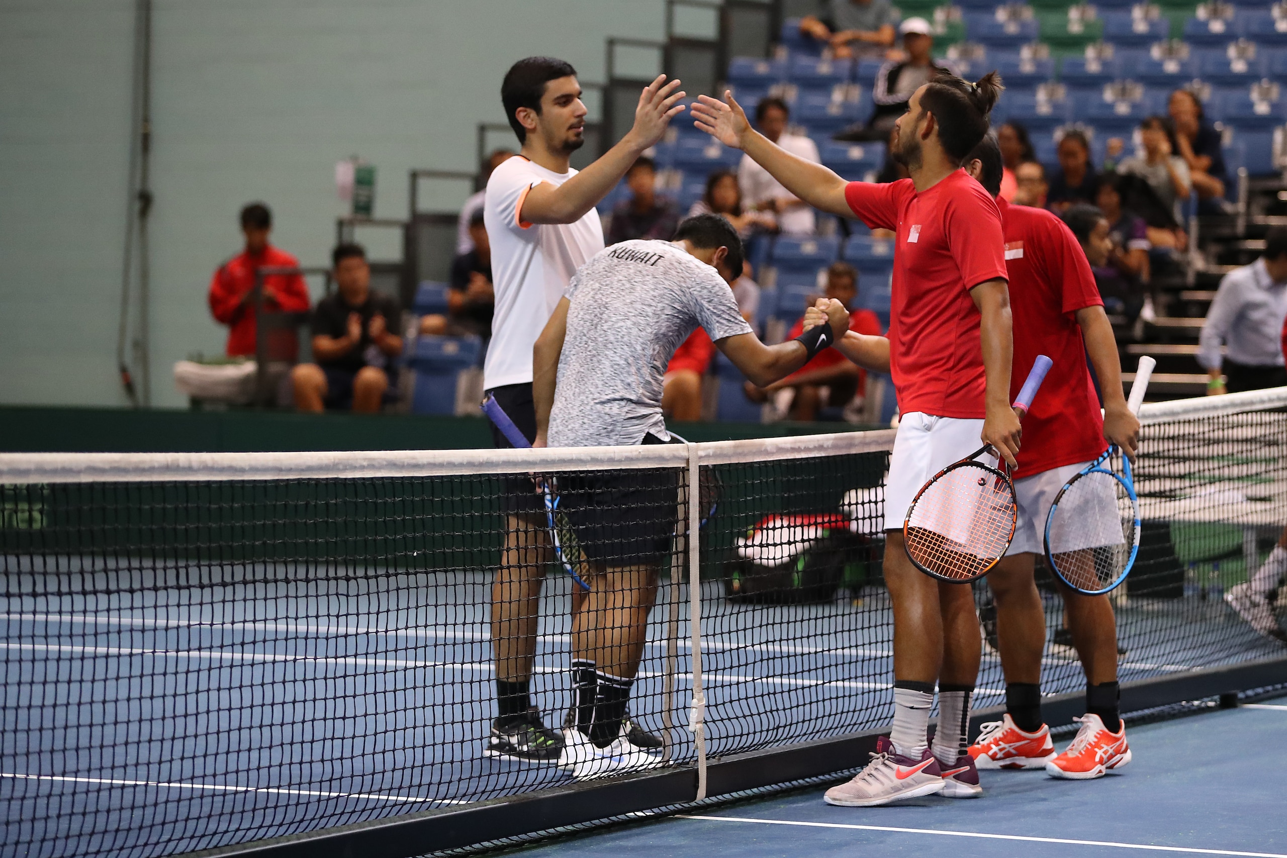 SINGAPORE, SINGAPORE - JUNE 26: Roy Hobbs and Jensen Hiu of Singapore celebrate match point during their Pool A mens doubles match against Abdulrahman Alawadhi and Essa Qabazard of Kuwait during day one of the Davis Cup Asia/Oceania Group III at OCBC Arena on June 26, 2019 in Singapore. (Photo by Lionel Ng/Getty Images for Singapore Sports Hub)