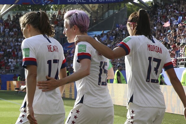 REIMS, FRANCE - JUNE 24: Megan Rapinoe of USA celebrates her winning goal on a penalty kick with Tobin Heath and Alex Morgan of USA during the 2019 FIFA Women's World Cup France Round Of 16 match between Spain and USA at Stade Auguste Delaune on June 24, 2019 in Reims, France. (Photo by Jean Catuffe/Getty Images)