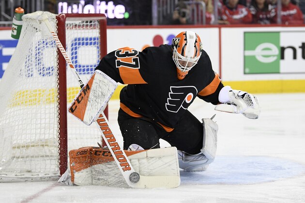 Philadelphia Flyers goaltender Brian Elliott (37) stops the puck during the first period of an NHL hockey game against the Washington Capitals, Sunday, March 24, 2019, in Washington. (AP Photo/Nick Wass)
