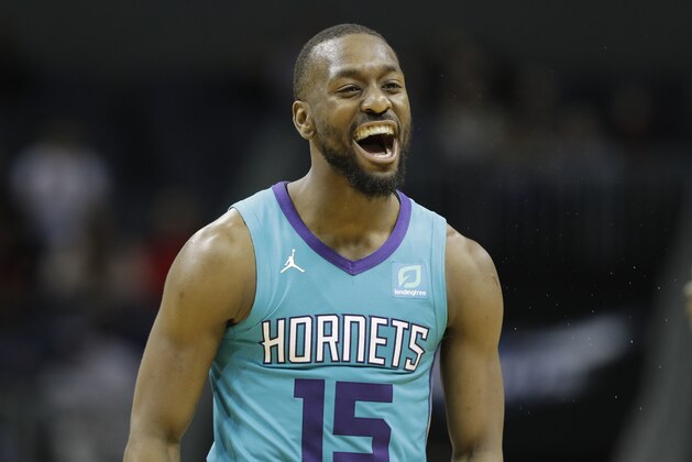 Charlotte Hornets guard Kemba Walker (15) reacts after a basket against the Washington Wizards during the second half of an NBA basketball game in Charlotte, N.C., Friday, Feb. 22, 2019. (AP Photo/Chuck Burton)