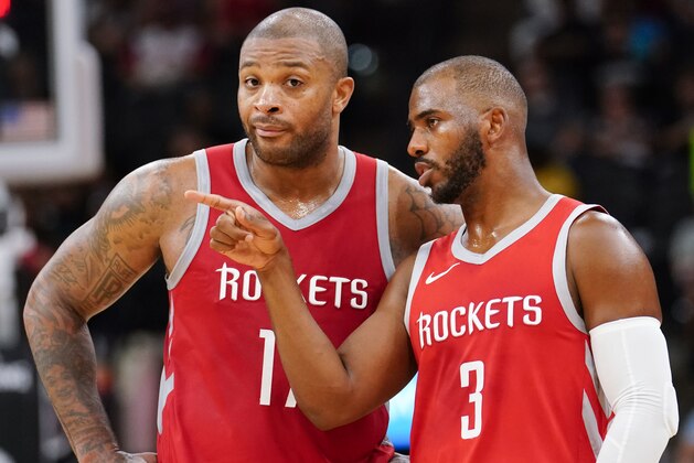 Houston Rockets' Chris Paul (3) and P.J. Tucker talk during the second half of an NBA preseason basketball game against the San Antonio Spurs, Sunday, Oct. 7, 2018, in San Antonio. (AP Photo/Darren Abate)