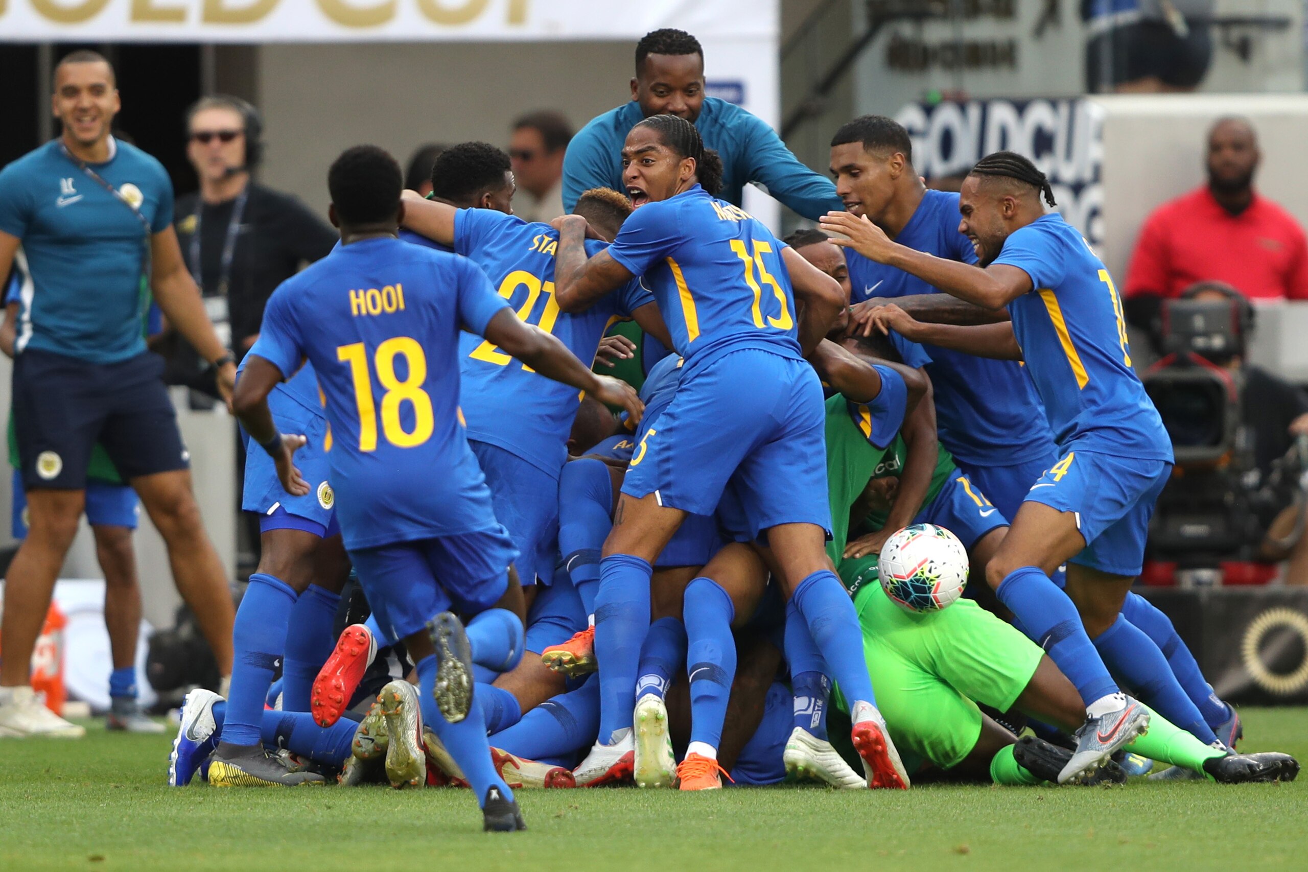 LOS ANGELES, CALIFORNIA - JUNE 25:   Darryl Lachman #4, Elson Hooi #18, Gervane Kastaneer #14,  and Ayrton Statie #21 of Curacao react to scoring in a goal in extra time during the second half of the Jamaica v Curacao: Group C - 2019 CONCACAF Gold Cup match at Banc of California Stadium on June 25, 2019 in Los Angeles, California. (Photo by Sean M. Haffey/Getty Images)