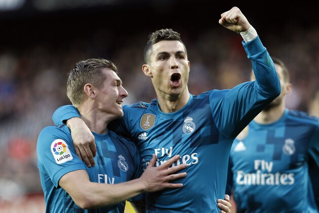Real Madrid's Cristiano Ronaldo, right, and Real Madrid's Toni Kroos, left, celebrates after toni scoring Valencia against during the Spanish La Liga soccer match between Valencia and Real Madrid at the Mestalla stadium in Valencia, Spain, Saturday, Jan. 27, 2018. (AP Photo/Alberto Saiz)