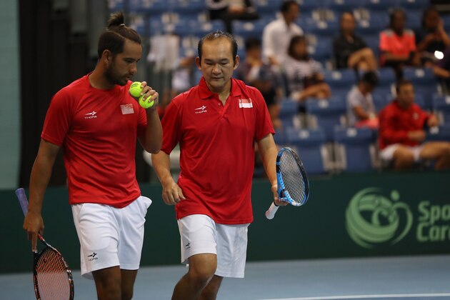 SINGAPORE, SINGAPORE - JUNE 26: Roy Hobbs and Jensen Hiu of Singapore in action during their Pool A mens doubles match against Abdulrahman Alawadhi and Essa Qabazard of Kuwait during day one of the Davis Cup Asia/Oceania Group III at OCBC Arena on June 26, 2019 in Singapore. (Photo by Lionel Ng/Getty Images for Singapore Sports Hub)