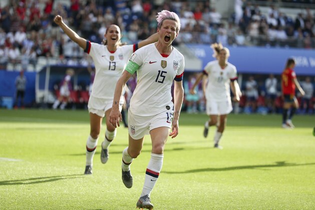 REIMS, FRANCE - JUNE 24: Megan Rapinoe of USA celebrates her winning goal on a penalty kick with Alex Morgan (#13) during the 2019 FIFA Women's World Cup France Round Of 16 match between Spain and USA at Stade Auguste Delaune on June 24, 2019 in Reims, France. (Photo by Jean Catuffe/Getty Images)