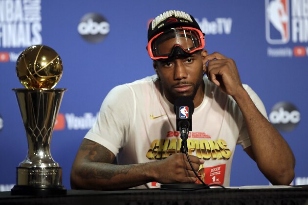 Toronto Raptors forward Kawhi Leonard speaks at a news conference alongside the NBA Finals Most Valuable Player trophy after the Raptors defeated the Golden State Warriors in Game 6 of basketball's NBA Finals in Oakland, Calif., Thursday, June 13, 2019. (AP Photo/Ben Margot)