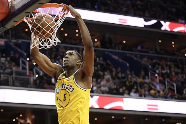 Golden State Warriors center Kevon Looney (5) dunks past Washington Wizards guard Tomas Satoransky (31) during the first half of an NBA basketball game Thursday, Jan. 24, 2019, in Washington. (AP Photo/Nick Wass)