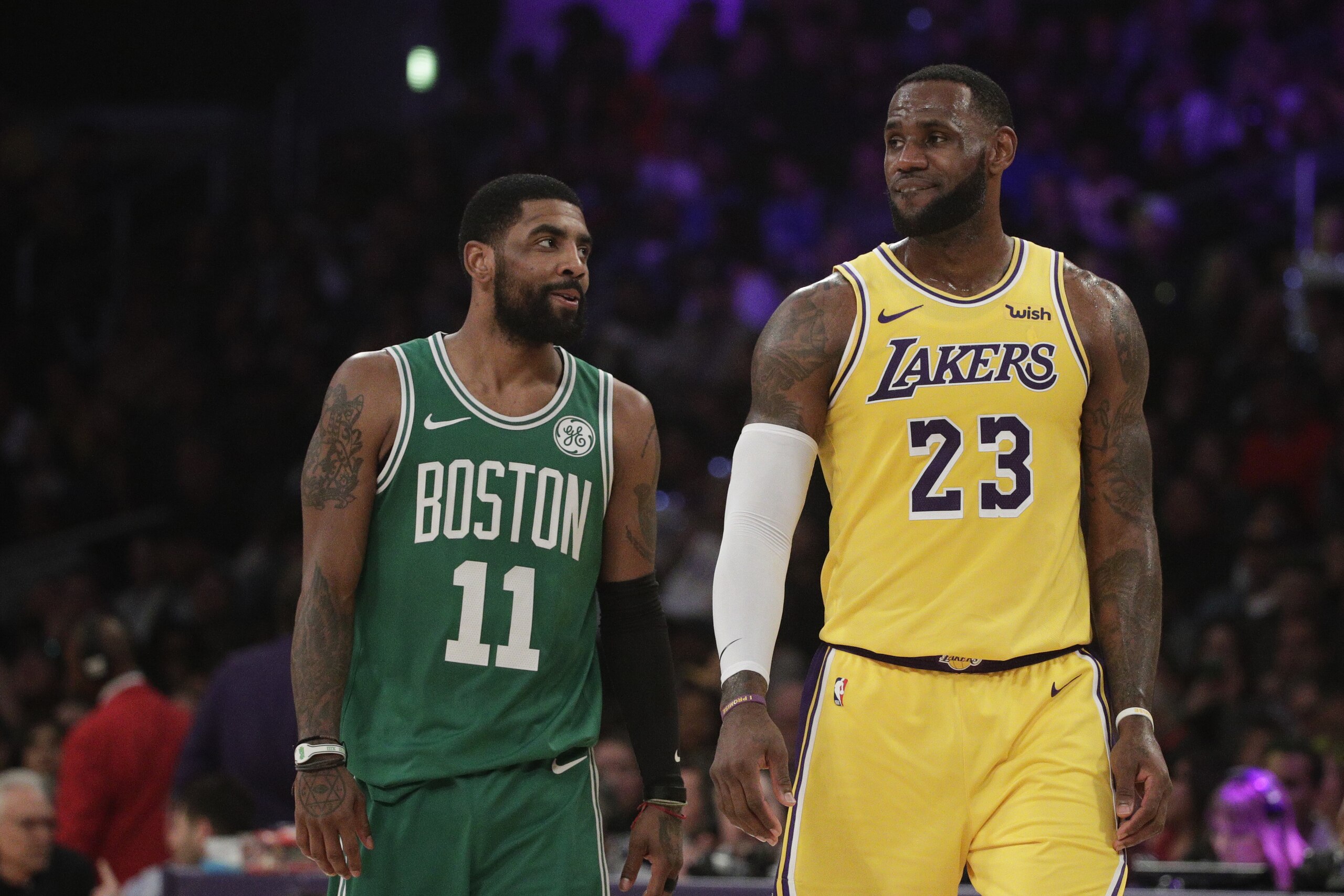 Los Angeles Lakers' LeBron James, right, and Boston Celtics' Kyrie Irving chat during the first half of an NBA basketball game, Saturday, March 9, 2019, in Los Angeles. (AP Photo/Jae C. Hong)