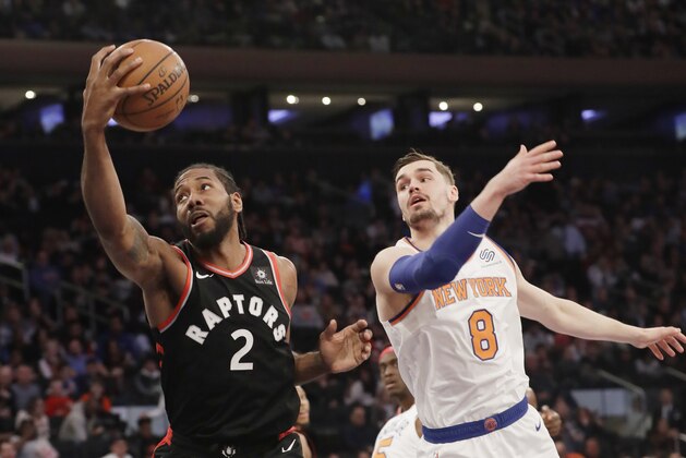 Toronto Raptors' Kawhi Leonard (2) catches a pass in front of New York Knicks' Mario Hezonja (8) during the first half of an NBA basketball game, Saturday, Feb. 9, 2019, in New York. (AP Photo/Frank Franklin II)