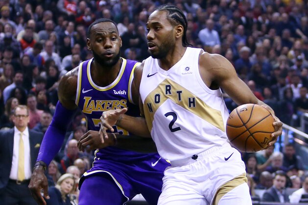 TORONTO, ON - MARCH 14:  Kawhi Leonard #2 of the Toronto Raptors dribbles the ball as LeBron James #23 of the Los Angeles Lakers defends during the first half of an NBA game at Scotiabank Arena on March 14, 2019 in Toronto, Canada.  NOTE TO USER: User expressly acknowledges and agrees that, by downloading and or using this photograph, User is consenting to the terms and conditions of the Getty Images License Agreement.  (Photo by Vaughn Ridley/Getty Images)