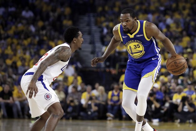 Golden State Warriors' Kevin Durant, right, drives the ball against Los Angeles Clippers' Lou Williams during the first half in Game 5 of a first-round NBA basketball playoff series, Wednesday, April 24, 2019, in Oakland, Calif. (AP Photo/Ben Margot)