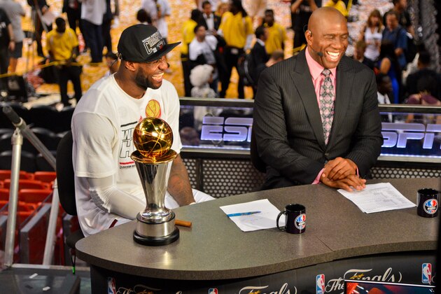 MIAMI, FL - JUNE 20: LeBron James #6 of the Miami Heat, sitting with the Bill Russell NBA Finals Most Valuable Player (MVP) trophy, is interviewed by NBA legend Magic Johnson following the Heat's victory against the San Antonio Spurs in Game Seven of the 2013 NBA Finals on June 20, 2013 at American Airlines Arena in Miami, Florida. NOTE TO USER: User expressly acknowledges and agrees that, by downloading and or using this photograph, User is consenting to the terms and conditions of the Getty Images License Agreement. Mandatory Copyright Notice: Copyright 2013 NBAE (Photo by Jesse D. Garrabrant/NBAE via Getty Images)