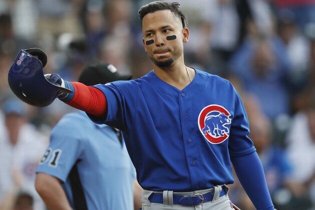 Chicago Cubs' Carlos Gonzalez gestures to the dugout of his former team, the Colorado Rockies, as he steps to bat in the second inning of a baseball game Monday, June 10, 2019, in Denver. (AP Photo/David Zalubowski)