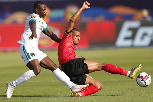 Angola's defender Bruno Gaspar (R) clears the ball ahead of Mauritania's forward Ismail Diakhite during the 2019 Africa Cup of Nations (CAN) Group E football match between Mauritania and Angola at the Suez Stadium on June 29, 2019. (Photo by FADEL SENNA / AFP)        (Photo credit should read FADEL SENNA/AFP/Getty Images)