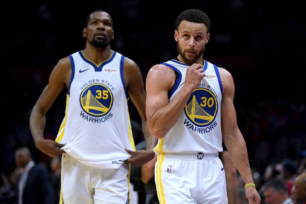 LOS ANGELES, CALIFORNIA - APRIL 26:  Stephen Curry #30 and Kevin Durant #35 of the Golden State Warriors react as they leave the game late in the fourth quarter with a lead in a 129-110 win over the LA Clippers during Game Six of Round One of the 2019 NBA Playoffs at Staples Center on April 26, 2019 in Los Angeles, California. (Photo by Harry How/Getty Images)  NOTE TO USER: User expressly acknowledges and agrees that, by downloading and or using this photograph, User is consenting to the terms and conditions of the Getty Images License Agreement.