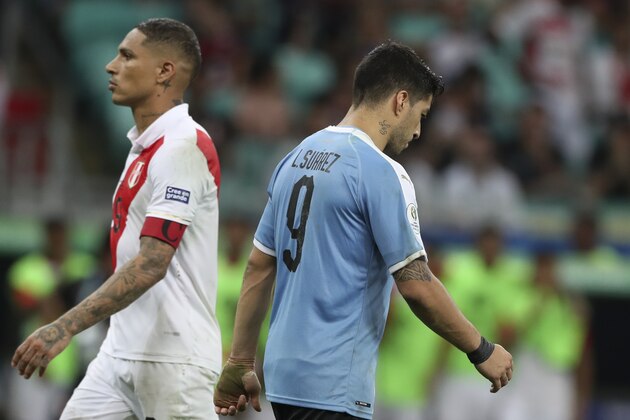 Uruguay's Luis Suarez, right, walks by Peru's Paolo Guerrero, left, after failing to score during the penalty shoot-out during a Copa America quarterfinal soccer match at the Arena Fonte Nova in Salvador, Brazil, Saturday, June 29, 2019. (AP Photo/Ricardo Mazalan)