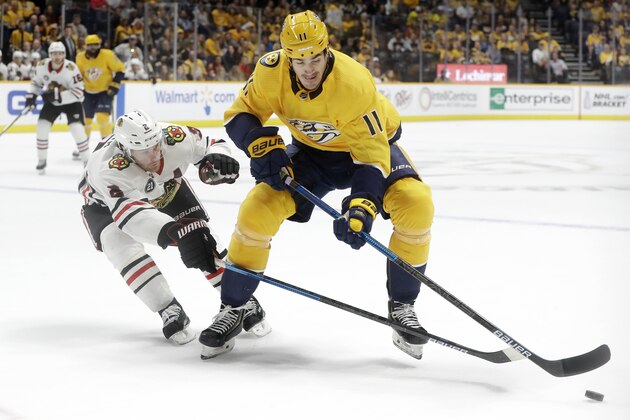 Chicago Blackhawks' Duncan Keith (2) and Nashville Predators' Brian Boyle (11) reach for the puck in the second period of an NHL hockey game Saturday, April 6, 2019, in Nashville, Tenn. (AP Photo/Mark Humphrey)