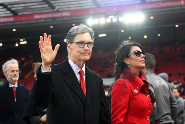 LIVERPOOL, ENGLAND - APRIL 26:  Liverpool owner John W. Henry and wife, Linda Pizzuti walk on the pitch prior to the Premier League match between Liverpool FC and Huddersfield Town at Anfield on April 26, 2019 in Liverpool, United Kingdom. (Photo by Michael Regan/Getty Images)
