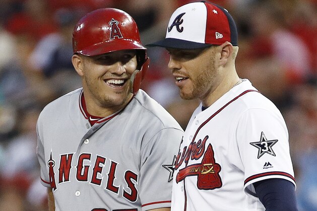 FILE - In this July 17, 2018, file photo, Los Angeles Angels of Anaheim outfielder Mike Trout (27) talks with Atlanta Braves first baseman Freddie Freeman (5) during the Major League Baseball All-star Game, in Washington. Opponents getting friendly during games hasn't always been such a thing. With so many players now switching teams, sharing agents or staying in touch via social media, there are more opportunities to get to know someone you might see only a handful of times. (AP Photo/Patrick Semansky, File)