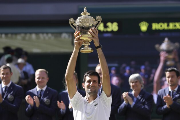 Serbia's Novak Djokovic lifts the trophy after winning the men's singles final match against Kevin Anderson of South Africa, at the Wimbledon Tennis Championships, in London, Sunday July 15, 2018.(AP Photo/Kirsty Wigglesworth)