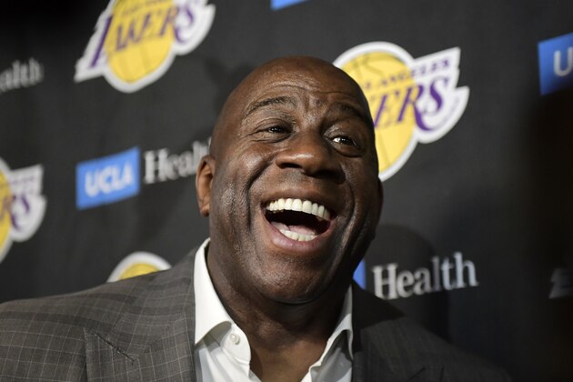 Magic Johnson speaks to reporters prior to an NBA basketball game between the Los Angeles Lakers and the Portland Trail Blazers on Tuesday, April 9, 2019, in Los Angeles. Johnson abruptly quit as the Lakers' president of basketball operations Tuesday night, citing his desire to return to the simpler life he enjoyed as a wealthy businessman and beloved former player before taking charge of the franchise just over two years ago. (AP Photo/Mark J. Terrill)