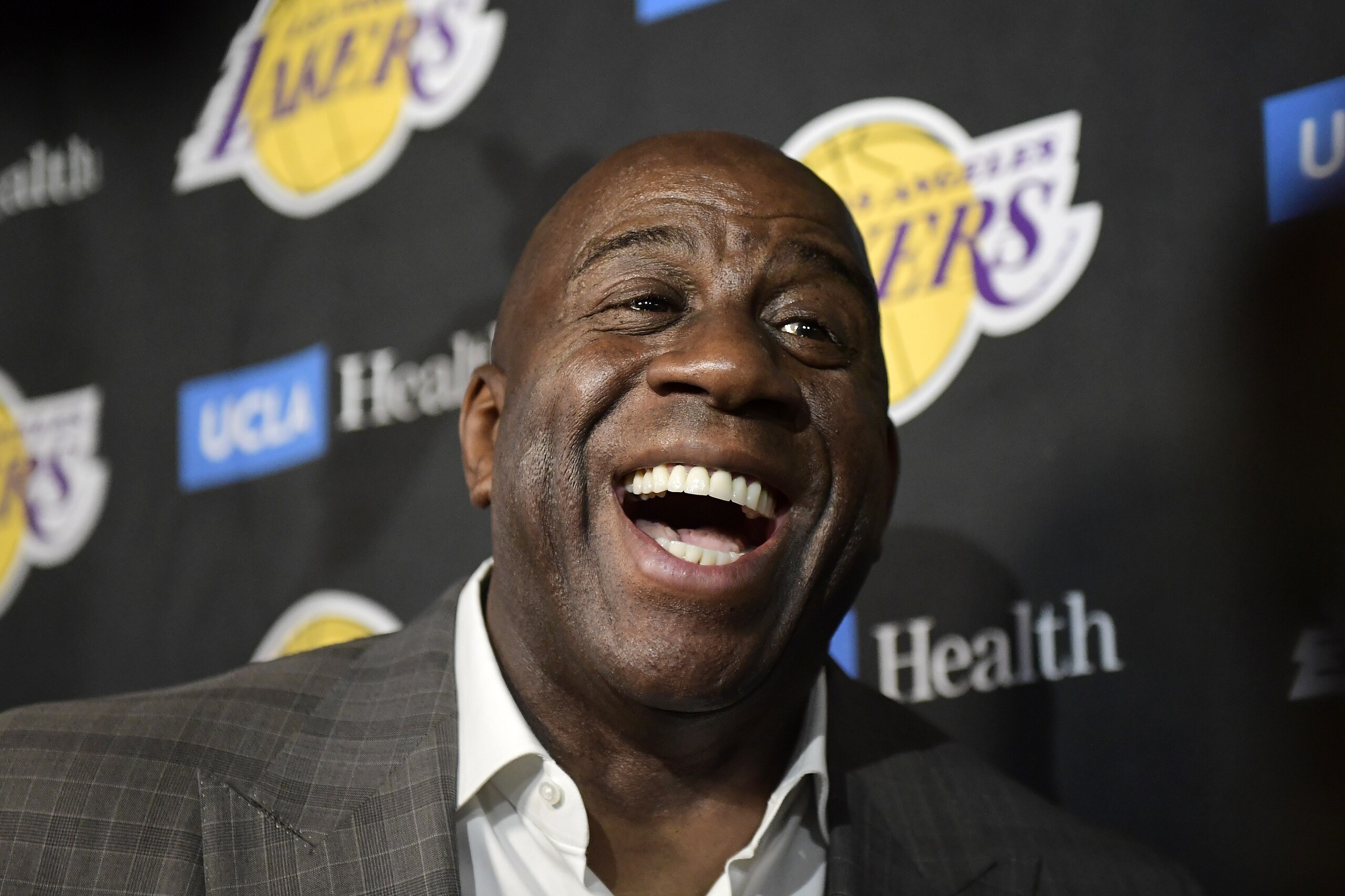 Magic Johnson speaks to reporters prior to an NBA basketball game between the Los Angeles Lakers and the Portland Trail Blazers on Tuesday, April 9, 2019, in Los Angeles. Johnson abruptly quit as the Lakers' president of basketball operations Tuesday night, citing his desire to return to the simpler life he enjoyed as a wealthy businessman and beloved former player before taking charge of the franchise just over two years ago. (AP Photo/Mark J. Terrill)