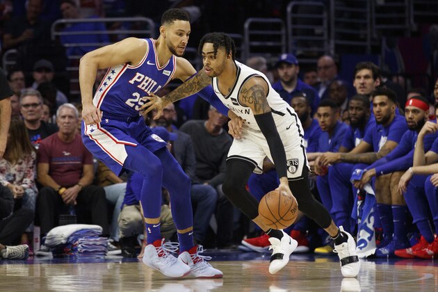 Brooklyn Nets' D'Angelo Russell, right, in action against Philadelphia 76ers' Ben Simmons, left, of Australia, during the first half in Game 5 of a first-round NBA basketball playoff series, Tuesday, April 23, 2019, in Philadelphia. The 76ers won 122-100. (AP Photo/Chris Szagola)