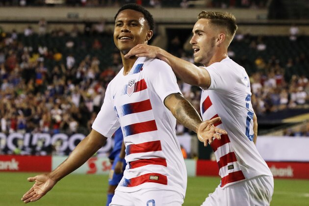 USA's Tyler Boyd (R) embraces teammate Weston McKennie after McKennie scored a goal in the first half during the CONCACAF Gold Cup quarterfinal football match between USA and Curacao in Philadelphia, Pennsylvania, on June 30, 2019. (Photo by DOMINICK REUTER / AFP)        (Photo credit should read DOMINICK REUTER/AFP/Getty Images)