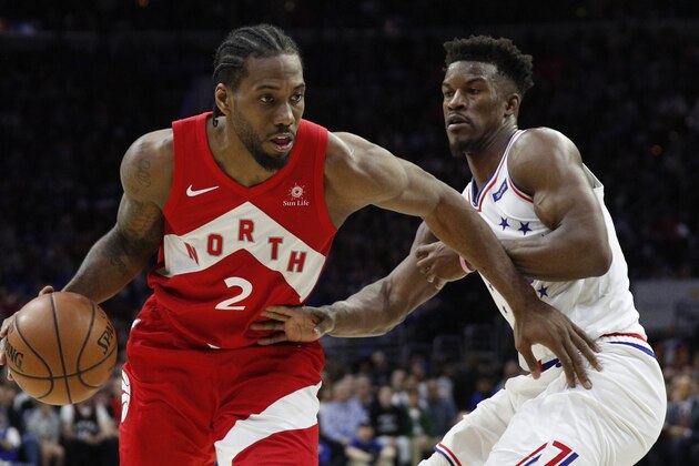 Toronto Raptors' Kawhi Leonard, left, drives against Philadelphia 76ers' Jimmy Butler, right, during the second half of Game 4 of a second-round NBA basketball playoff series, Sunday, May 5, 2019, in Philadelphia. The Raptors won 101-96. (AP Photo/Chris Szagola)
