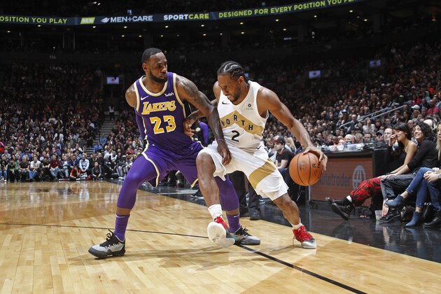 TORONTO, CANADA - MARCH 14: Kawhi Leonard #2 of the Toronto Raptors handles the ball against LeBron James #23 of the Los Angeles Lakers on March 14, 2019 at the Scotiabank Arena in Toronto, Ontario, Canada.  NOTE TO USER: User expressly acknowledges and agrees that, by downloading and or using this Photograph, user is consenting to the terms and conditions of the Getty Images License Agreement.  Mandatory Copyright Notice: Copyright 2019 NBAE (Photo by Mark Blinch/NBAE via Getty Images)