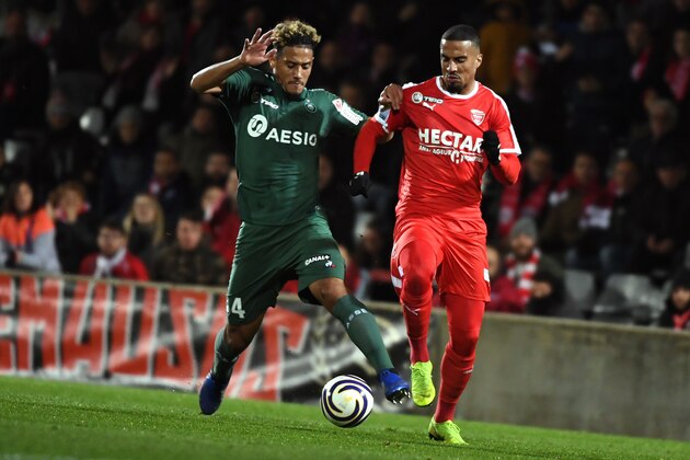 Saint-Etienne's French defender William Saliba (L) vies with Nîmes' Moroccan forward Rachid Alioui during the French League Cup round of 16 football match between Nimes Olympique and AS Saint-Etienne at the Costières stadium in Nîmes, southern France on November 27, 2018. (Photo by PASCAL GUYOT / AFP)        (Photo credit should read PASCAL GUYOT/AFP/Getty Images)
