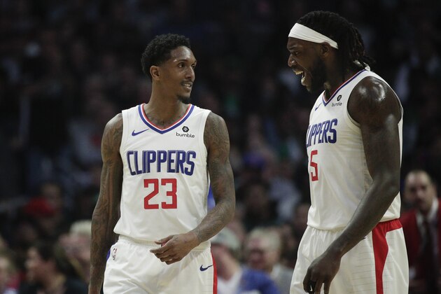 Los Angeles Clippers' Lou Williams, left, and Montrezl Harrell celebrate a basket made by Williams during the second half of an NBA basketball game against the Boston Celtics Monday, March 11, 2019, in Los Angeles. The Clippers won 140-115. (AP Photo/Jae C. Hong)