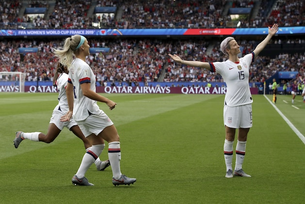 United States' Megan Rapinoe, right, celebrates after scoring her team's first goal during the Women's World Cup quarterfinal soccer match between France and the United States at Parc des Princes in Paris, France, Friday, June 28, 2019. (AP Photo/Alessandra Tarantino)