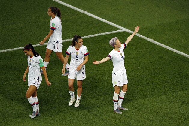 United States' Megan Rapinoe, right, celebrates after scoring her side's second goal during the Women's World Cup quarterfinal soccer match between France and the United States at the Parc des Princes, in Paris, Friday, June 28, 2019. (AP Photo/Francois Mori)