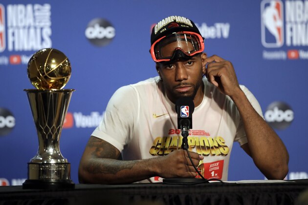 Toronto Raptors forward Kawhi Leonard speaks at a news conference alongside the NBA Finals Most Valuable Player trophy after the Raptors defeated the Golden State Warriors in Game 6 of basketball's NBA Finals in Oakland, Calif., Thursday, June 13, 2019. (AP Photo/Ben Margot)