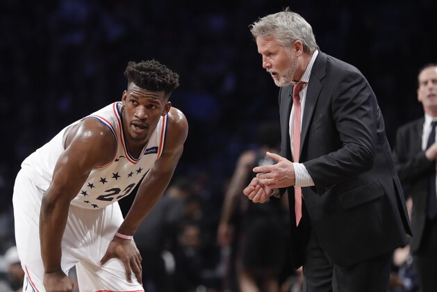 Philadelphia 76ers coach Brett Brown, right, talks to Jimmy Butler during the first half in Game 3 of the team's first-round NBA basketball playoff series against the Brooklyn Nets on Thursday, April 18, 2019, in New York. (AP Photo/Frank Franklin II)