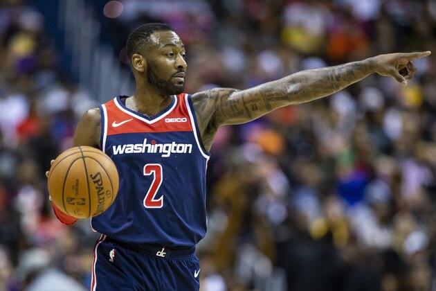 FILE - In this Dec. 16, 2018 file photo, Washington Wizards guard John Wall (2) dribbles the ball during the second half of an NBA basketball game, in Washington. The Washington Wizards said point Wall will be sidelined for more than another year because he ruptured his left Achilles tendon after slipping and falling at home. The team said Tuesday, Feb. 5, 2019, that Wall’s tendon surgery has not been scheduled. He should be able to return to full basketball activity about a year after the operation. (AP Photo/Al Drago, File)
